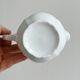 Old white porcelain milk jug, cream jug with relief.