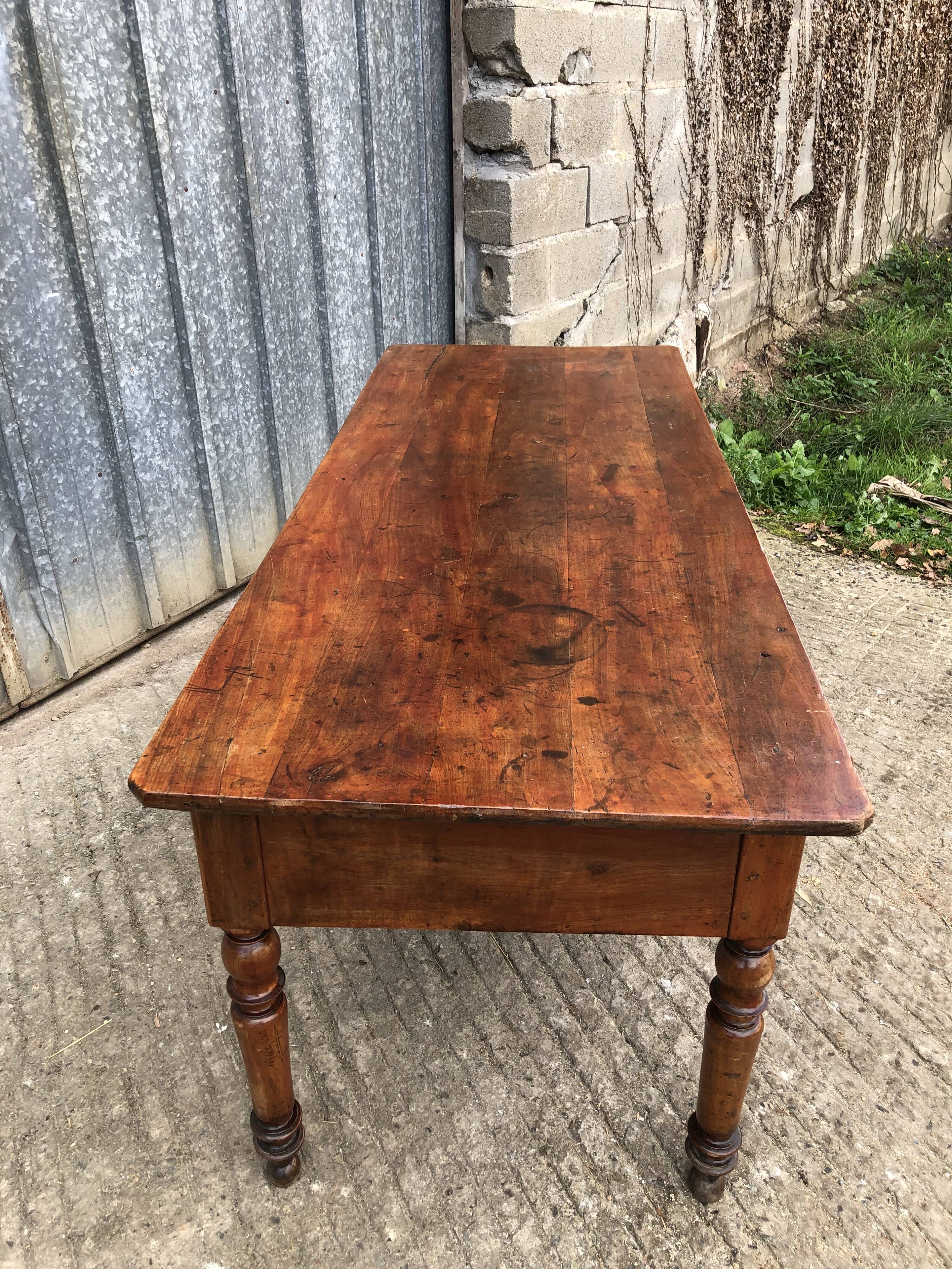 Old farmhouse table in solid cherry wood with 2 front drawers.