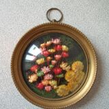 Old medallion frame bouquet of dried flowers glass and plastic retro decoration