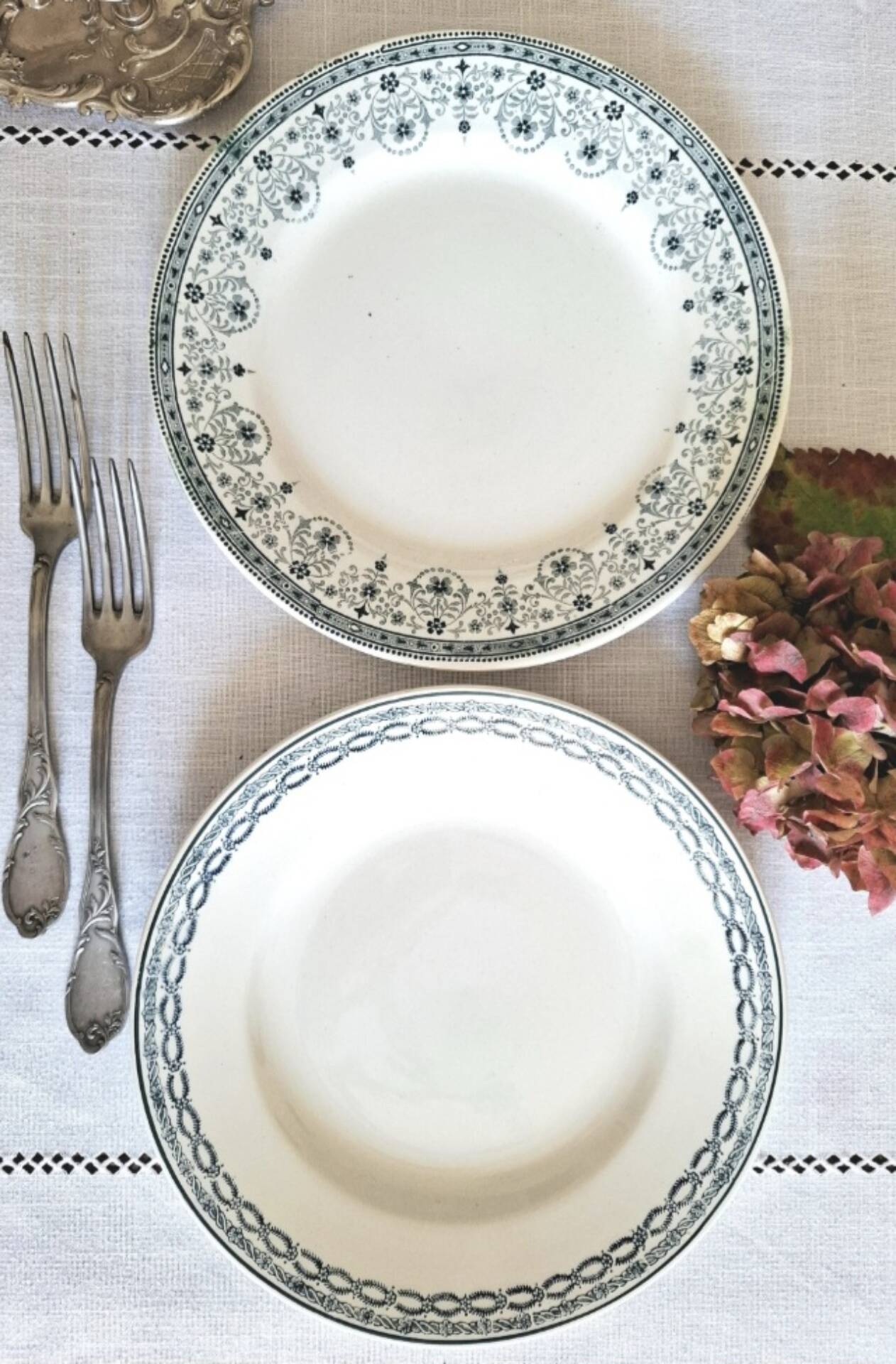 Old mismatched flat plates made of ironstone earthenware.