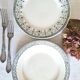 Old mismatched flat plates made of ironstone earthenware.
