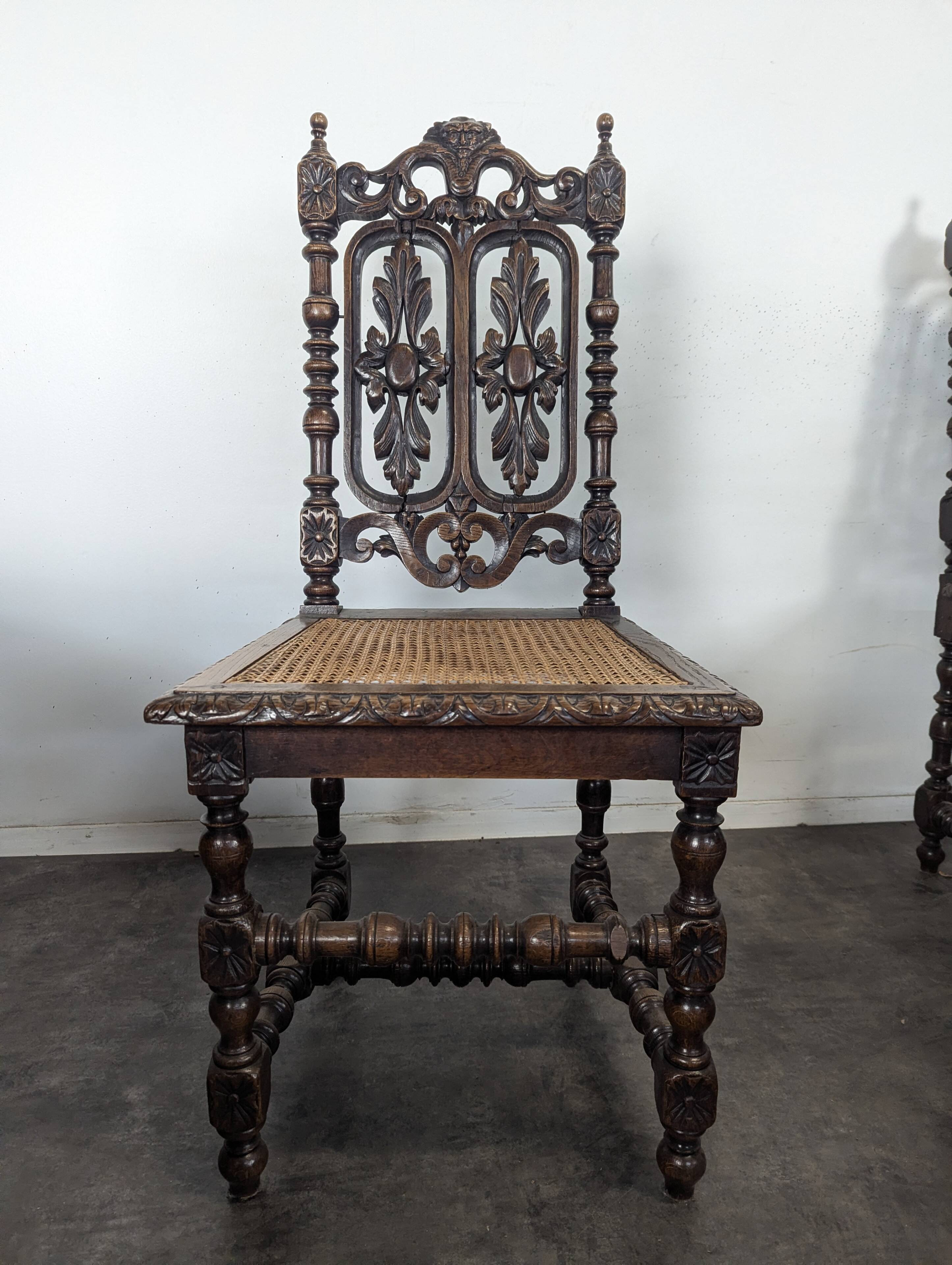 Set of 6 Henri II chairs in carved openwork oak with caned seats.