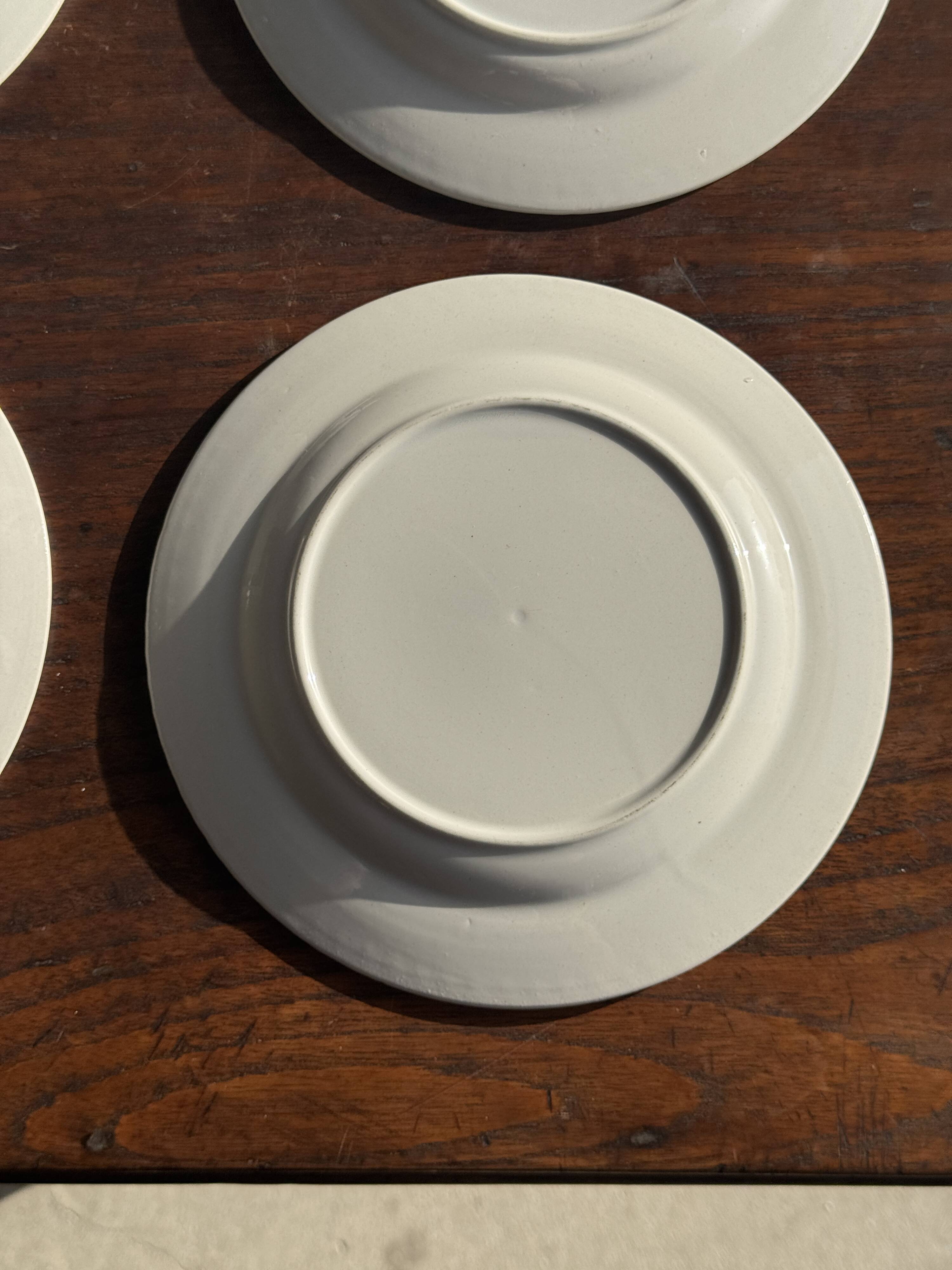 Set of 4 small dessert plates with a vintage stylised flower pattern.