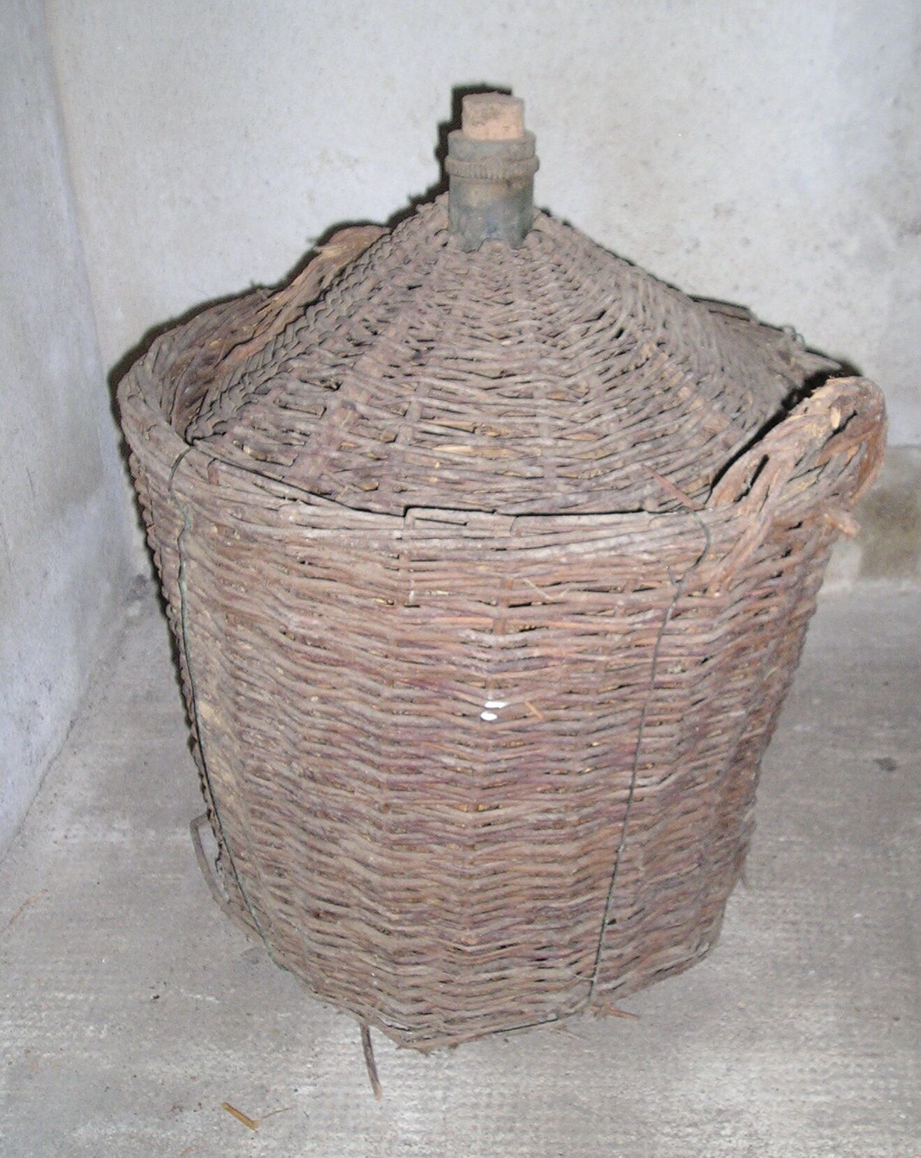 Old glass in her wicker basket demijohn