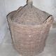 Old glass in her wicker basket demijohn