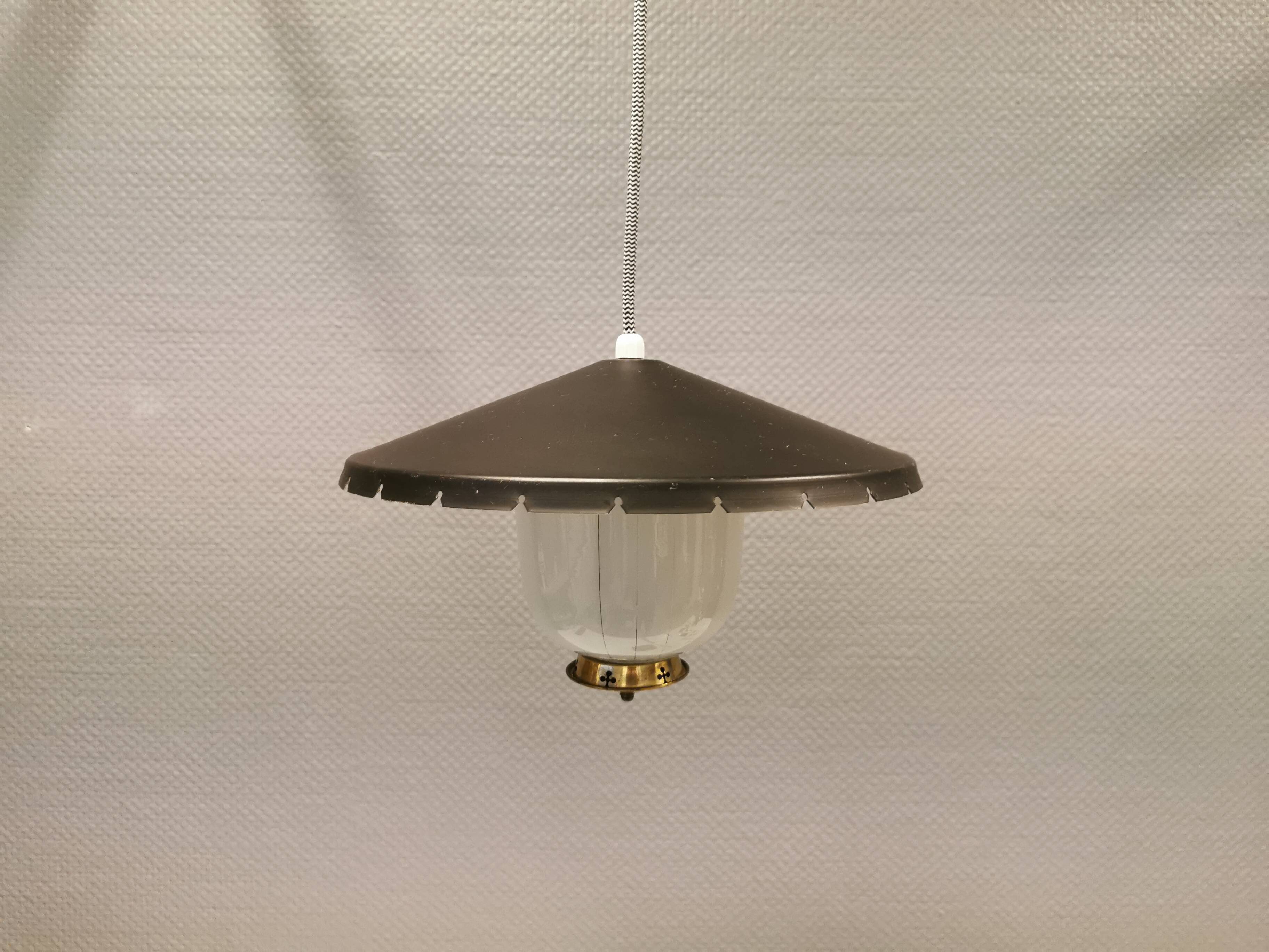 Hanging lamp in glass with black lacquered metal shade and brass base.