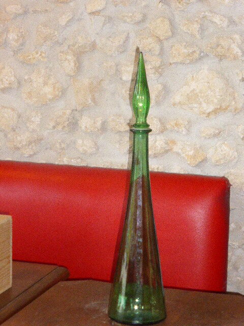 Vintage green faceted glass bottle with its cap 1970