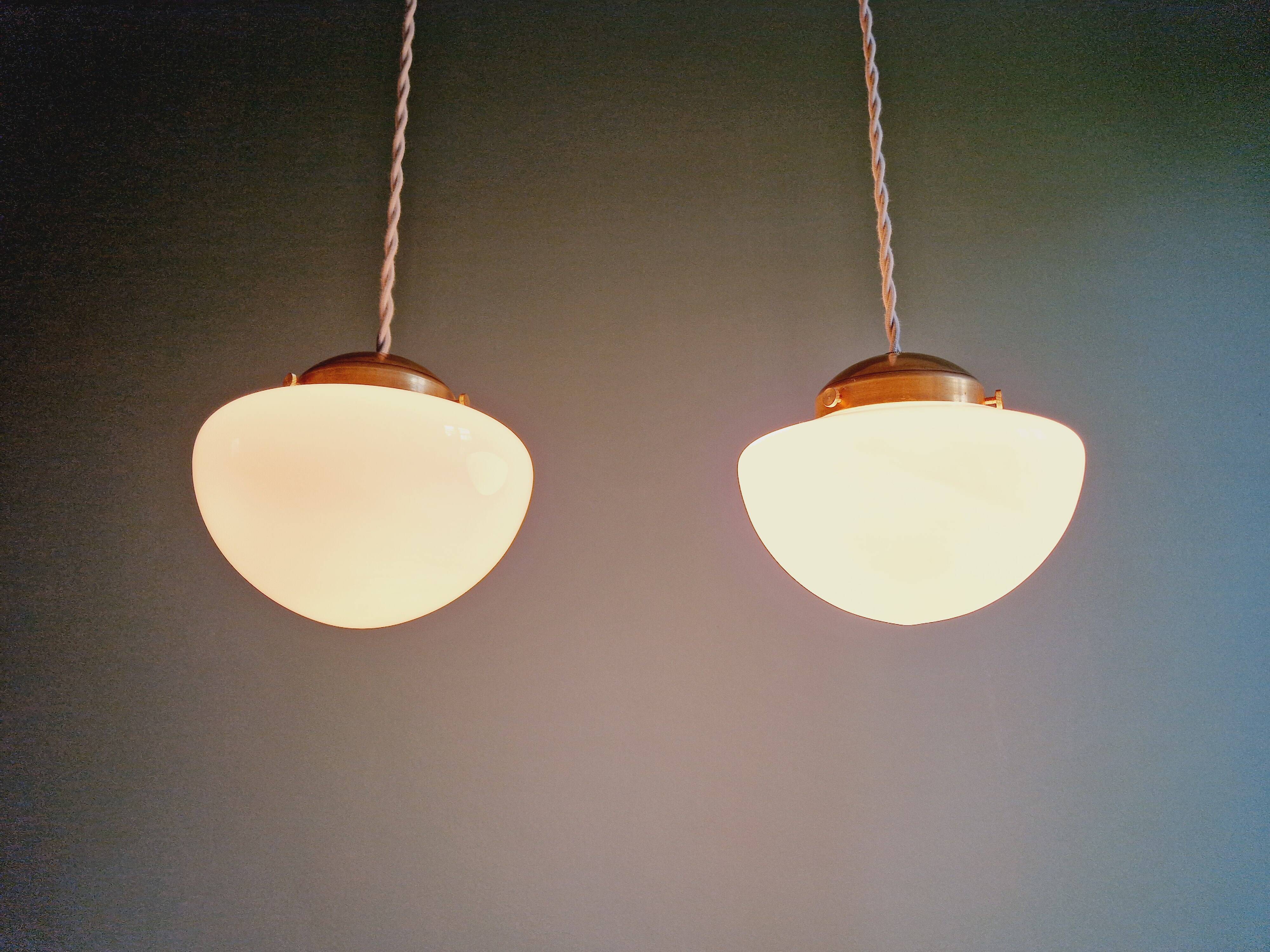 Duo of Art Deco suspensions in white opaline, 1920s-30s