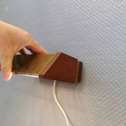 Fuga wall lamp in solid brass and teak wood was designed by Jo Hammerborg for Fog & Mørup in 1966.