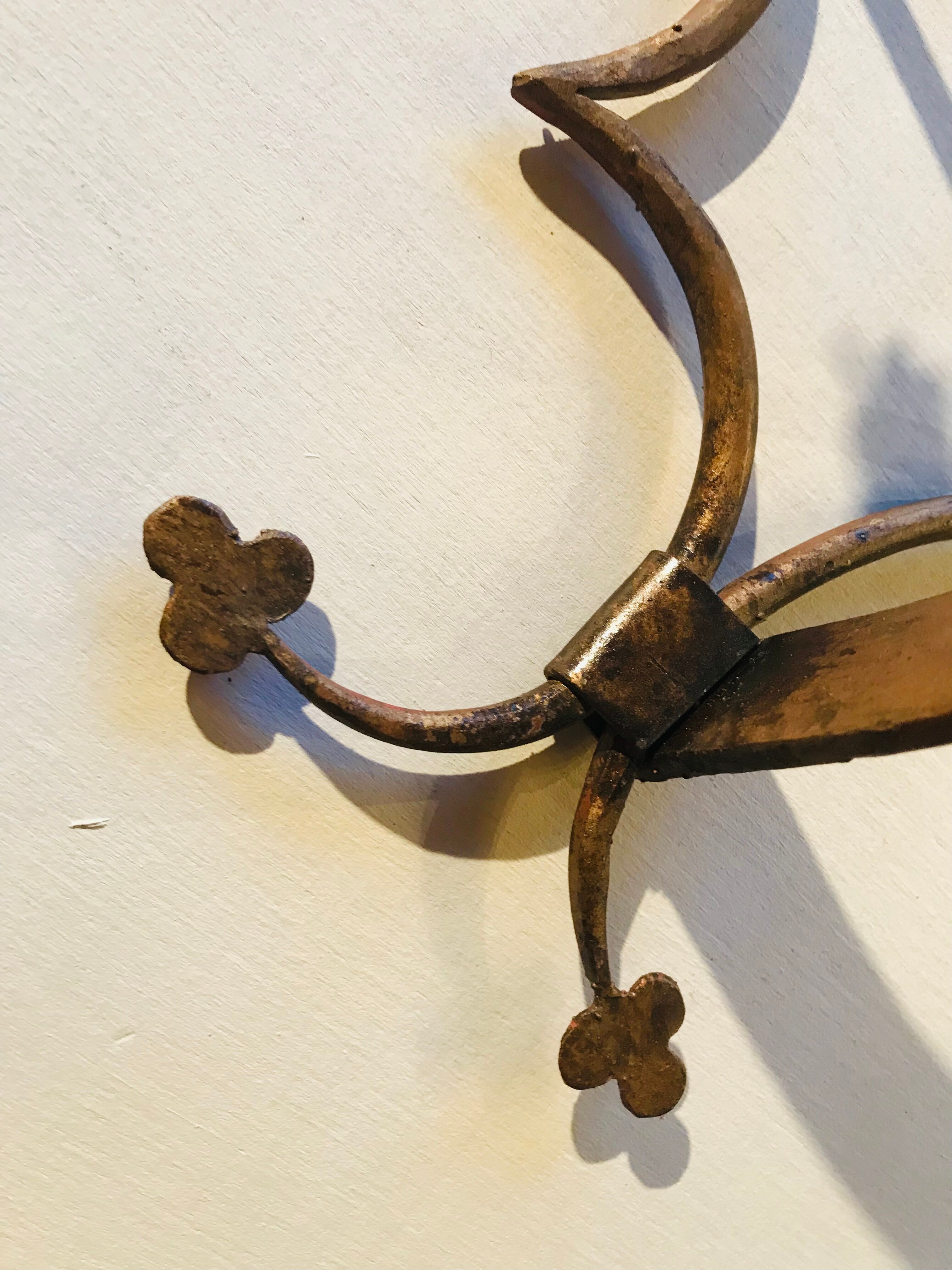 Pair of gilded metal sconces decorated with clovers.