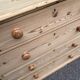 Victorian commode from the 19th century stripped to raw solid wood with ceramic knobs.