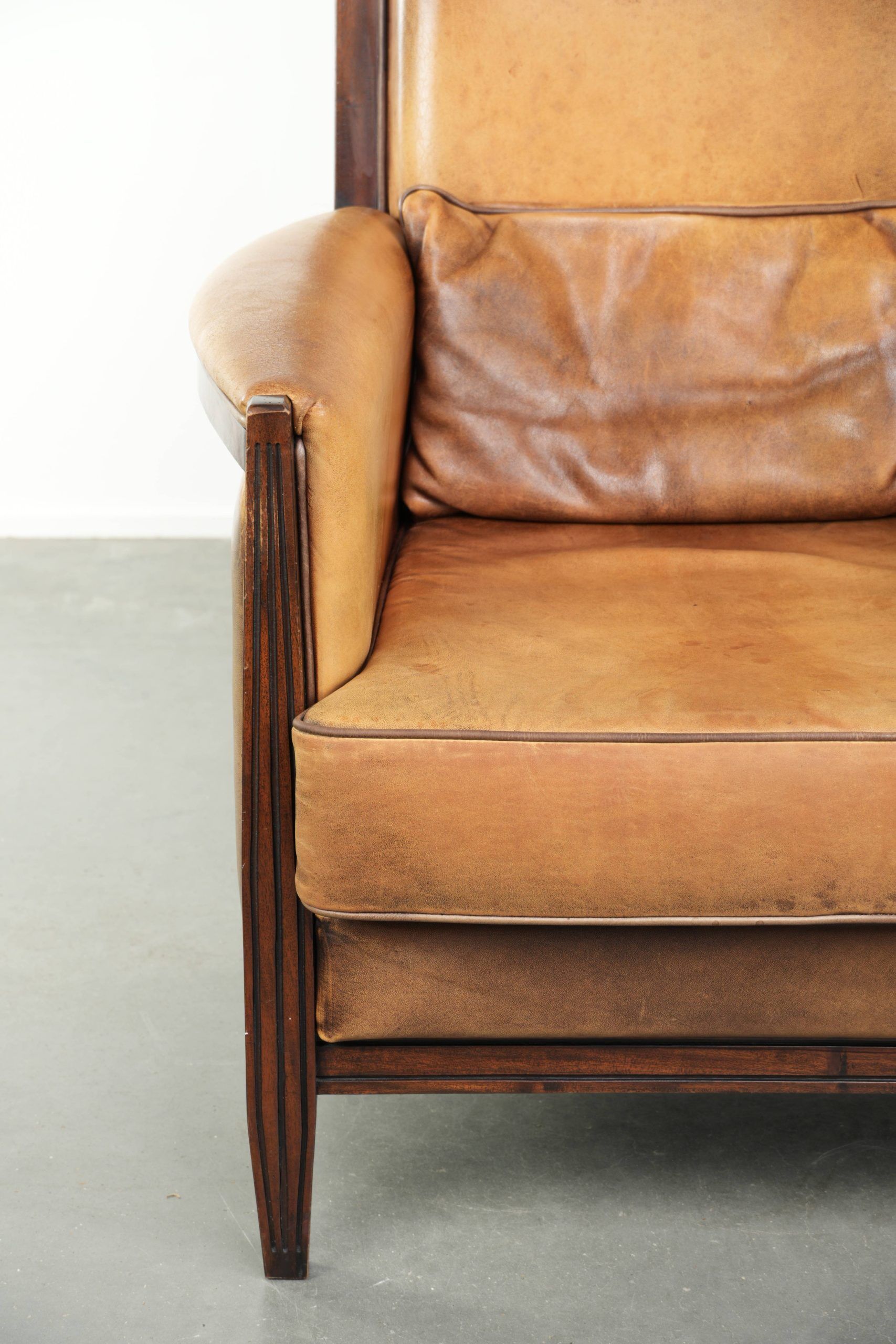 Cognac-coloured Art Deco design armchair made of sheepskin with a high back