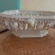 Malicorne fruit bowl in white pierced faience with monogram TE.