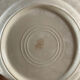 Four beige speckled plates