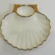 Shell-shaped porcelain pocket bowl from Queen’s Porcelain, with a gold rim.