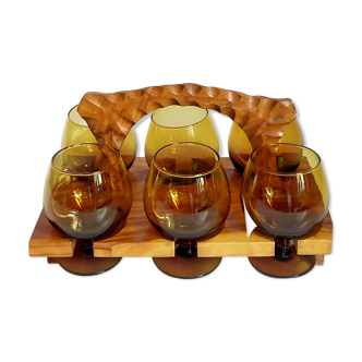 Six vintage amber glass digestive glasses and their wooden display