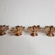 Set of four copper candlesticks in the shape of lotus flowers