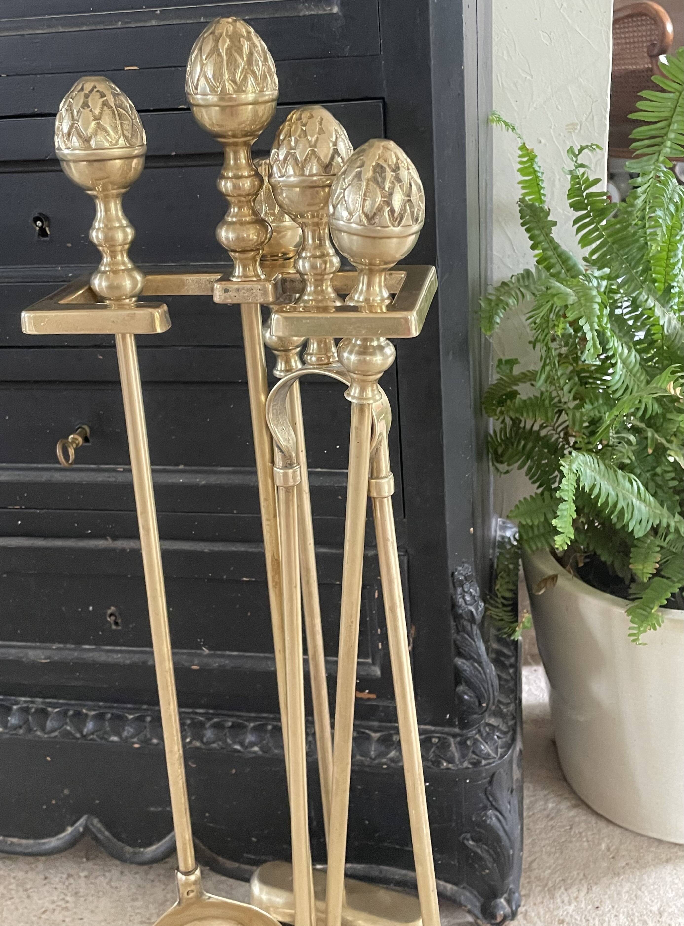Brass fireplace tools in the style of Maison Baguès.