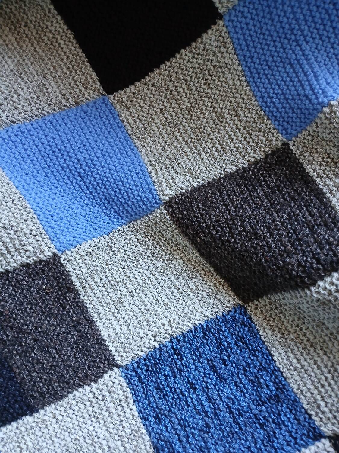 Hand knitted patchwork plaid