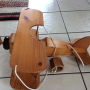 Light wood hanging in the shape of an airplane. Electric.Year 70.