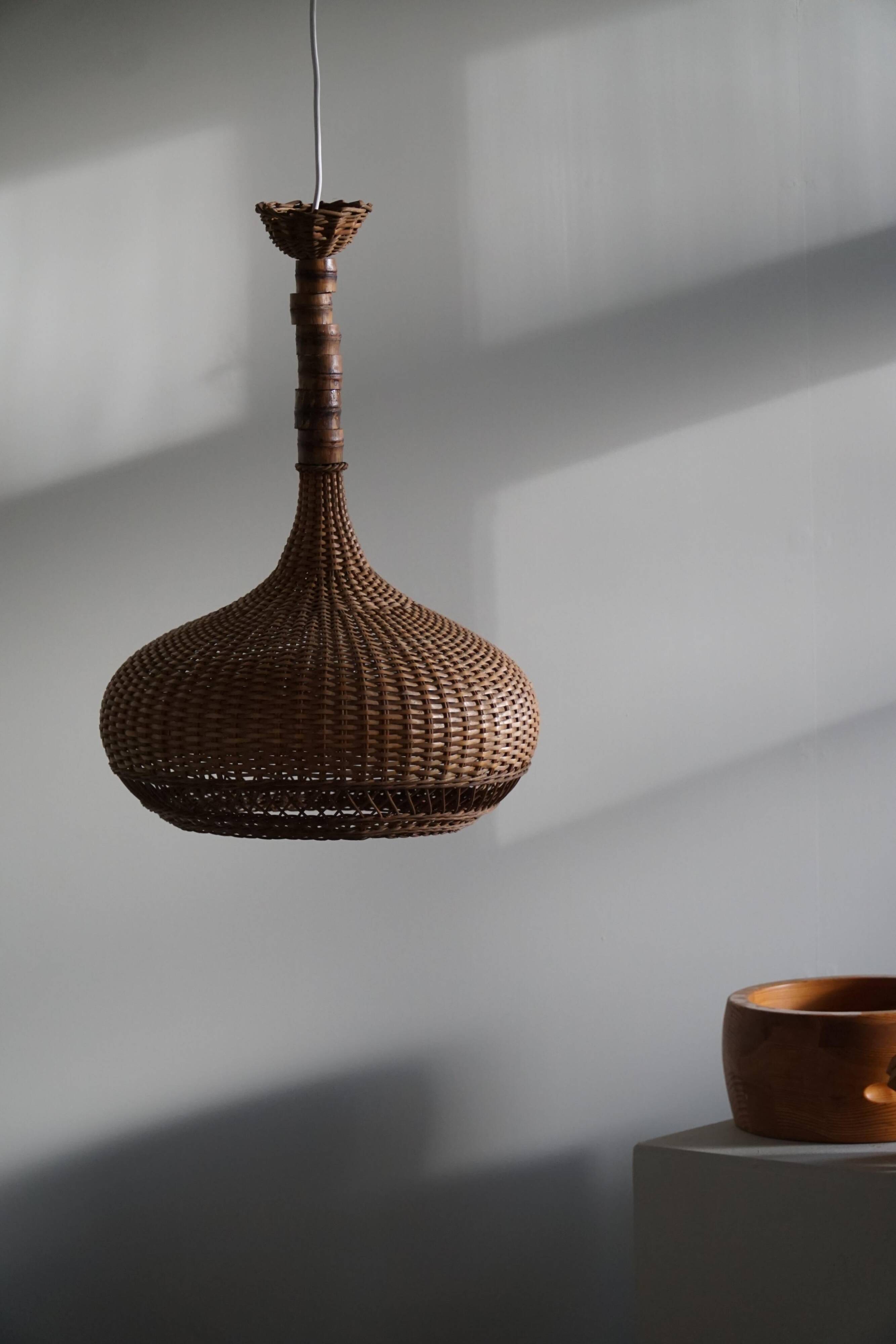 Vintage Danish mid-century rattan pendant light, made in the 1960s.