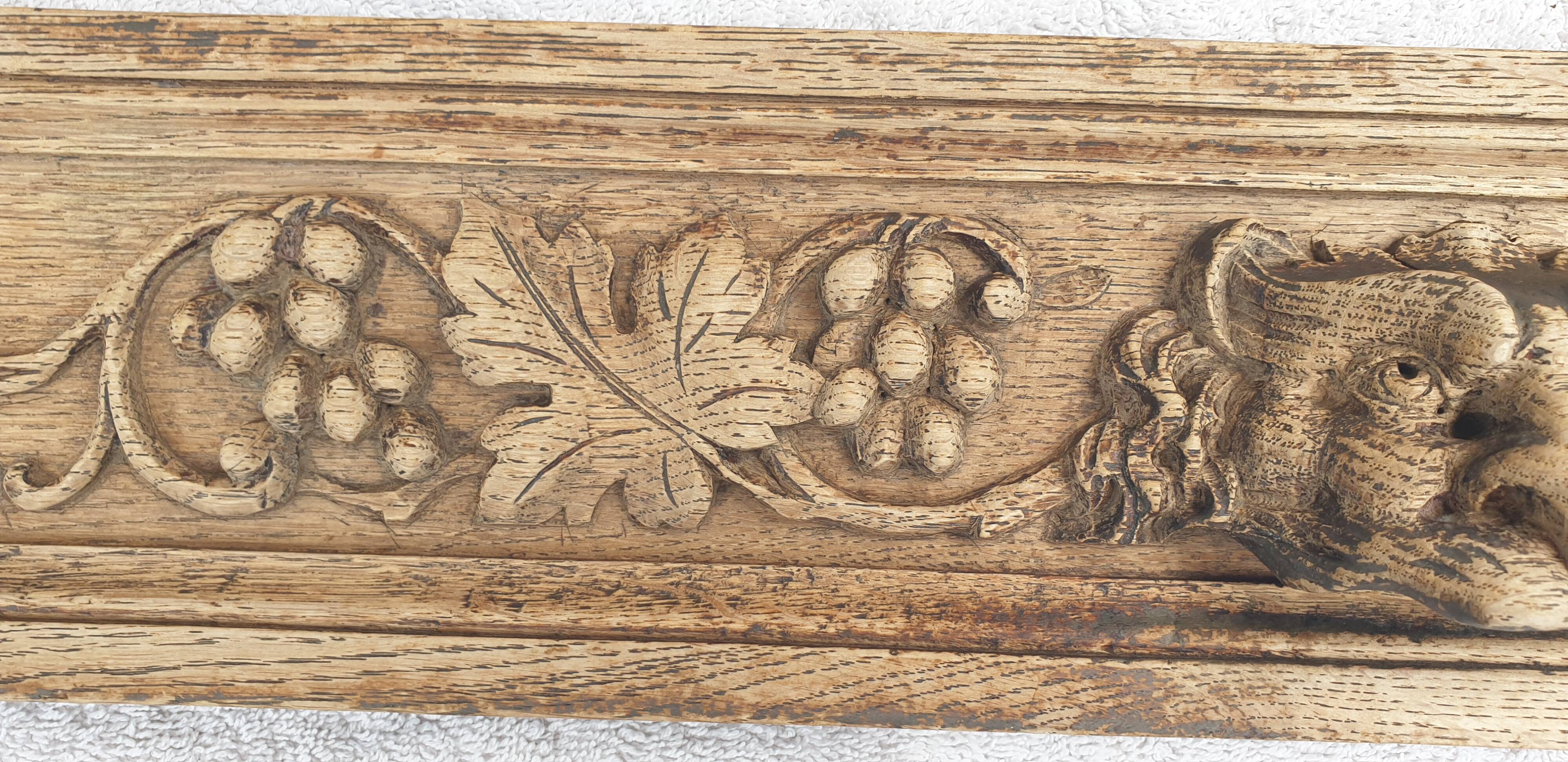 Natural wood pediment with bunches of grapes