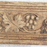 Natural wood pediment with bunches of grapes