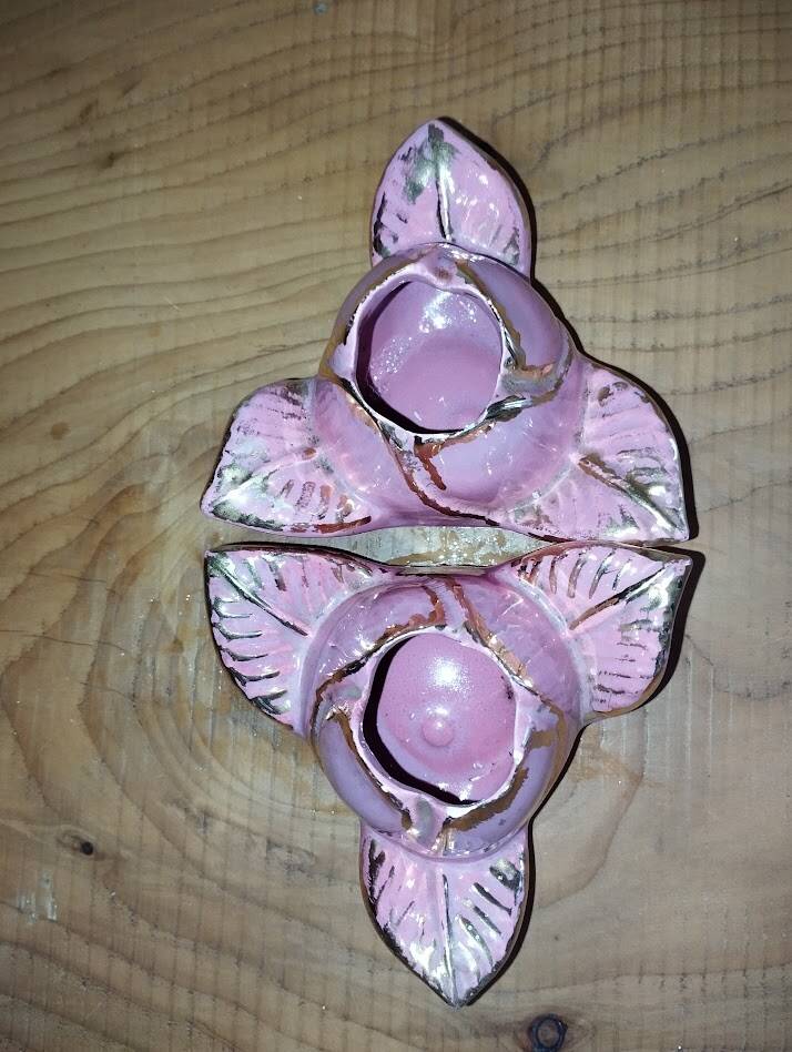 A pair of pink earthenware candlesticks (1940s–50s)