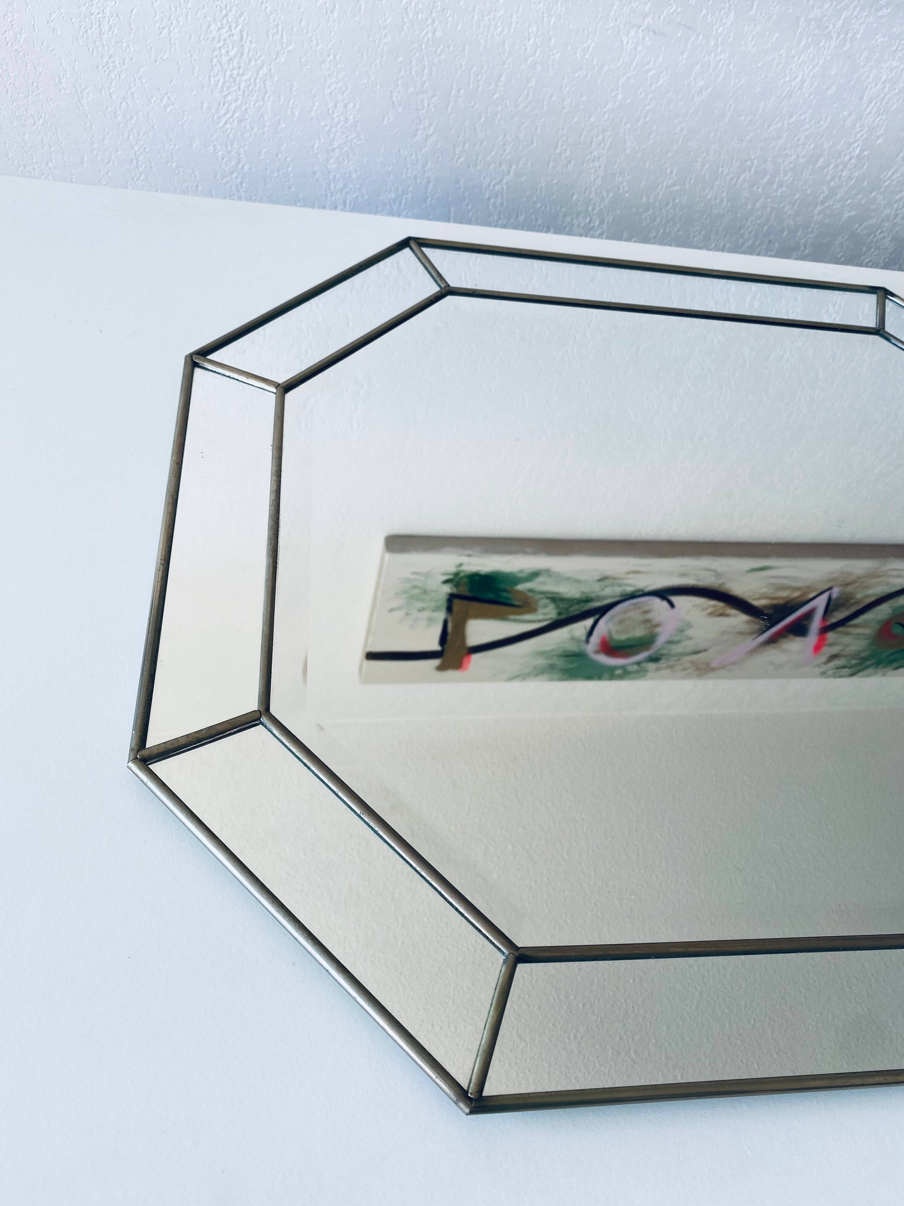 Old octagonal beveled mirror with parcloses