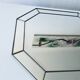Old octagonal beveled mirror with parcloses