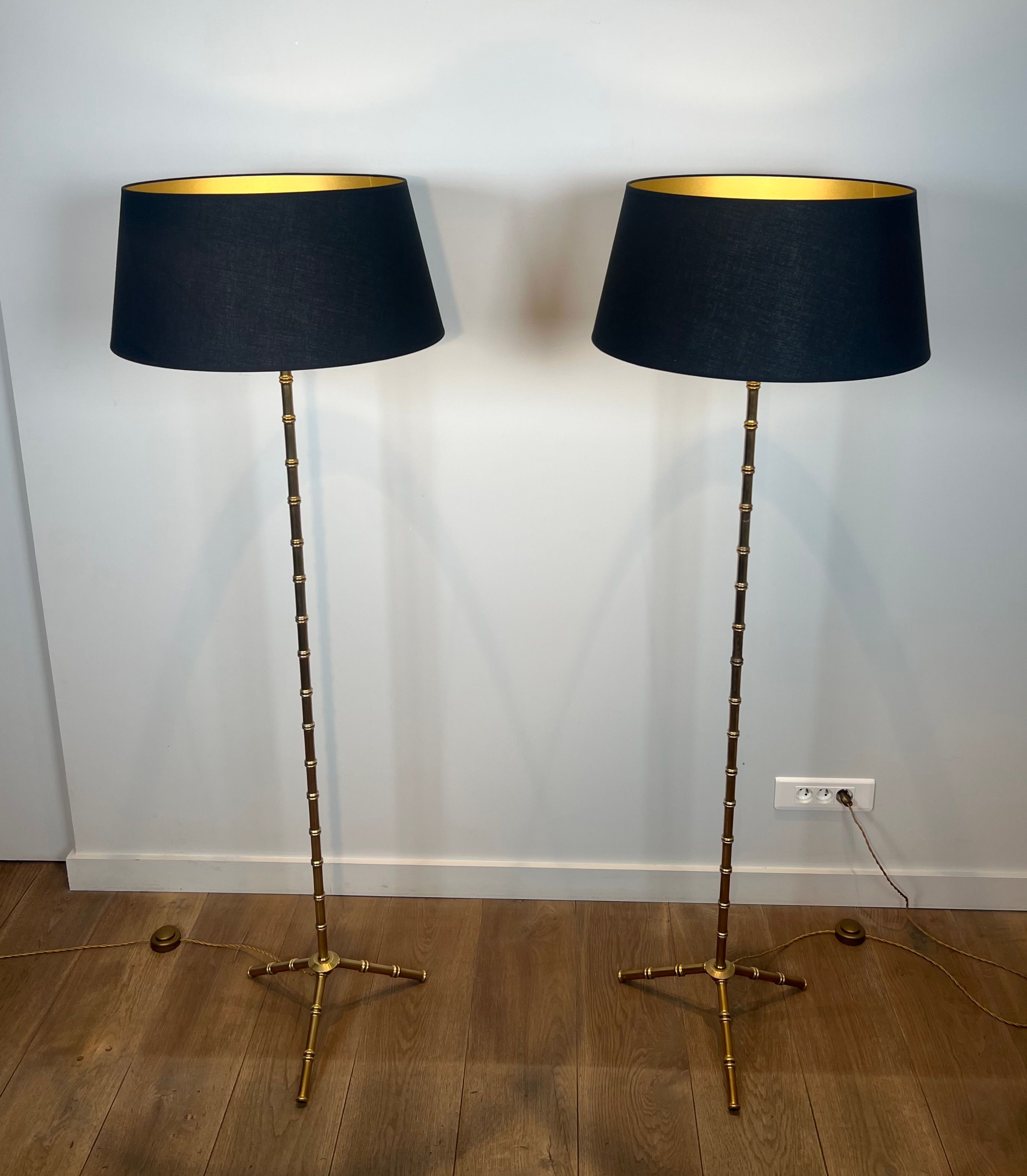 Pair of parquet floor lamps in faux-bamboo style in bronze and brass by Jacques Adnet.