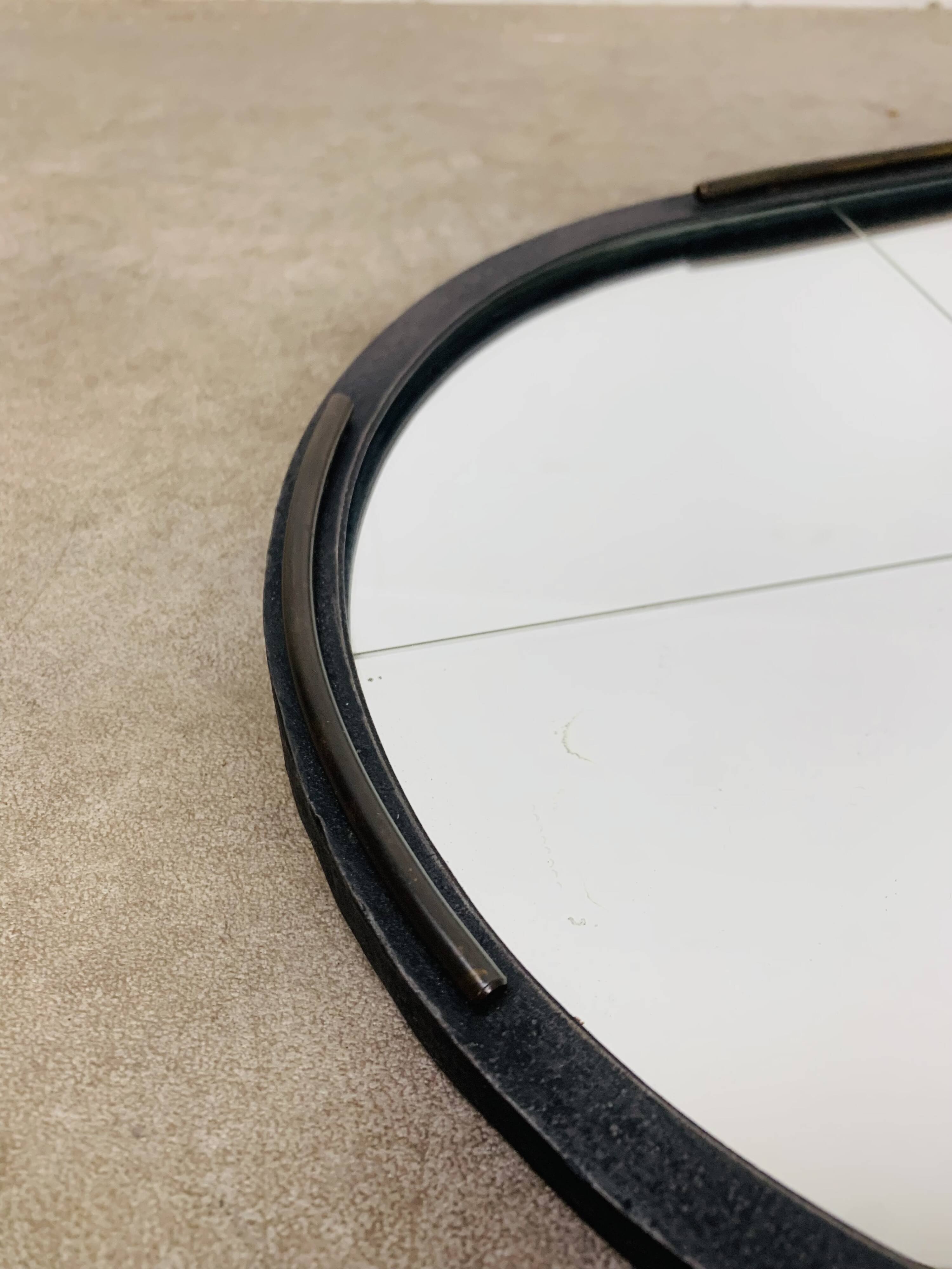 Oval mirror from the 1950s, wrought iron and brass.