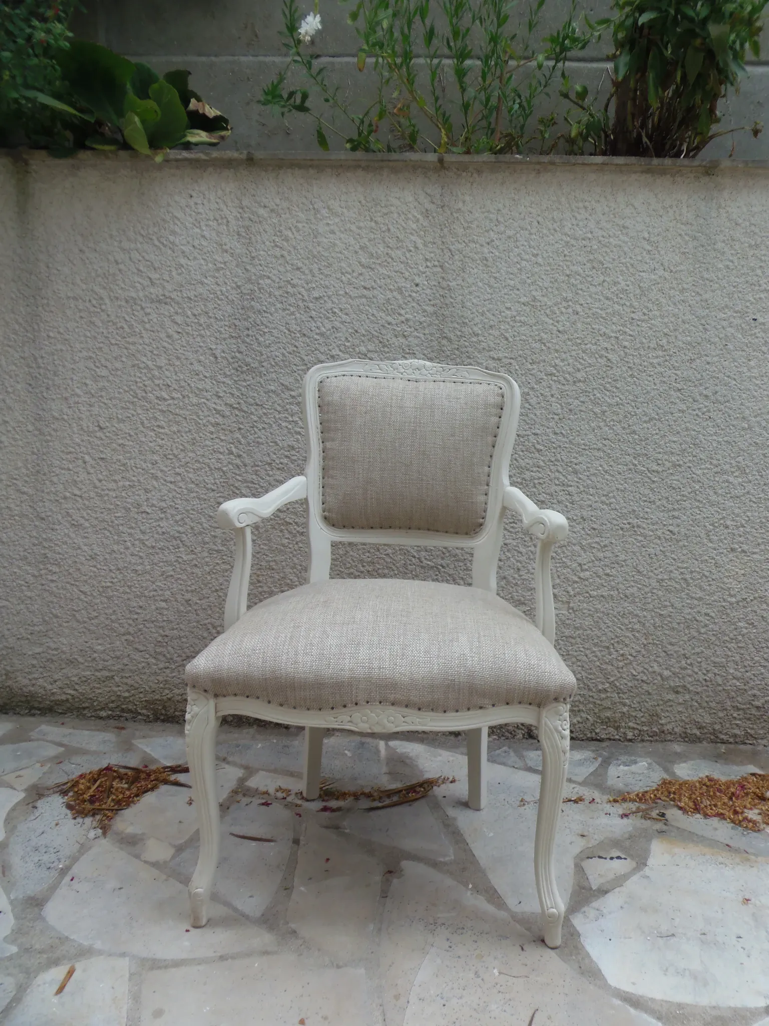 Louis XV style armchair, delicately patinated in a soft beige hue.