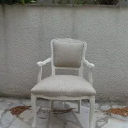 Louis XV style armchair, delicately patinated in a soft beige hue.