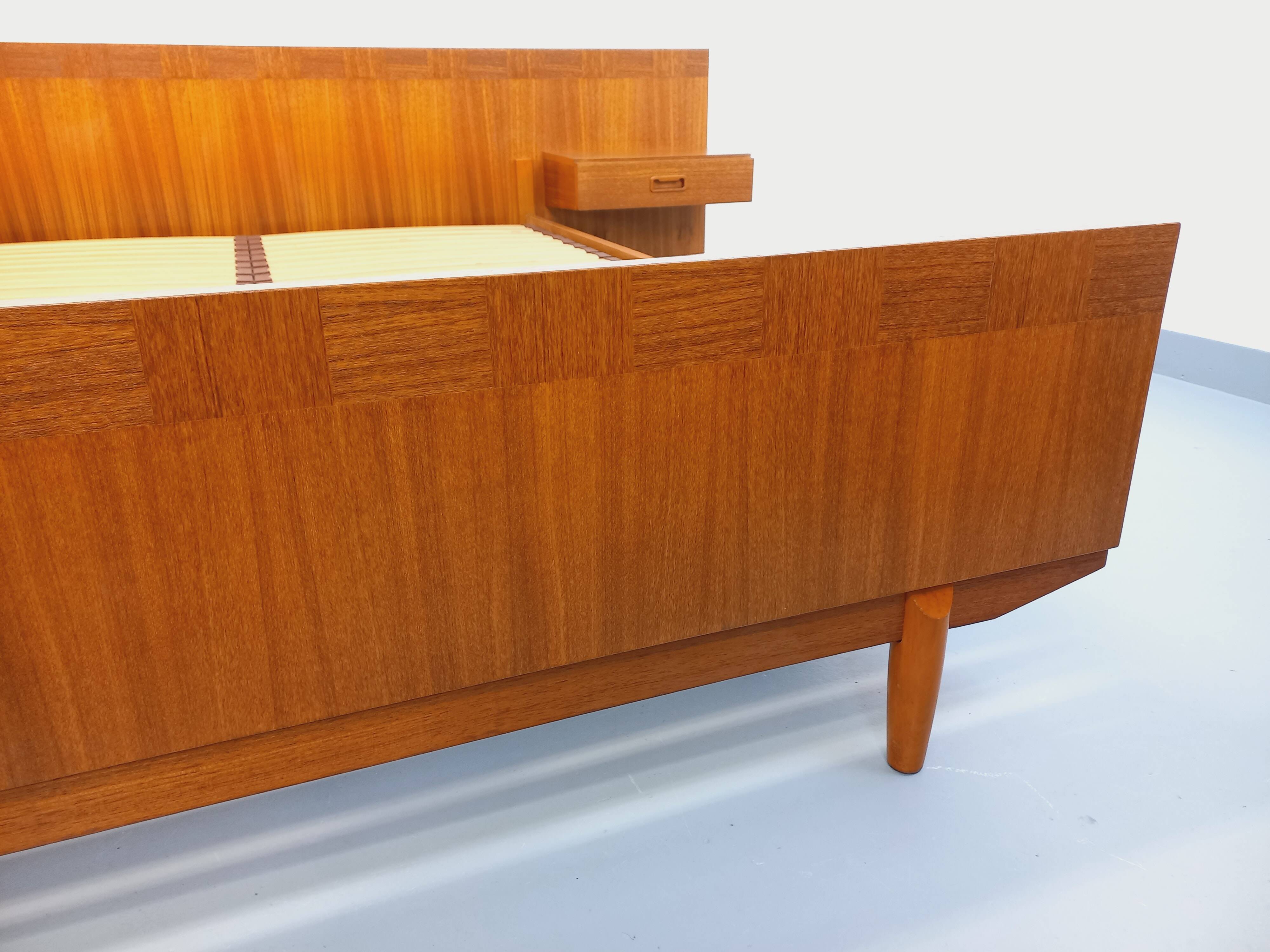 Double bed vintage Scandinavian in teak from the 1960s with integrated bedside tables.