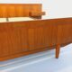 Double bed vintage Scandinavian in teak from the 1960s with integrated bedside tables.