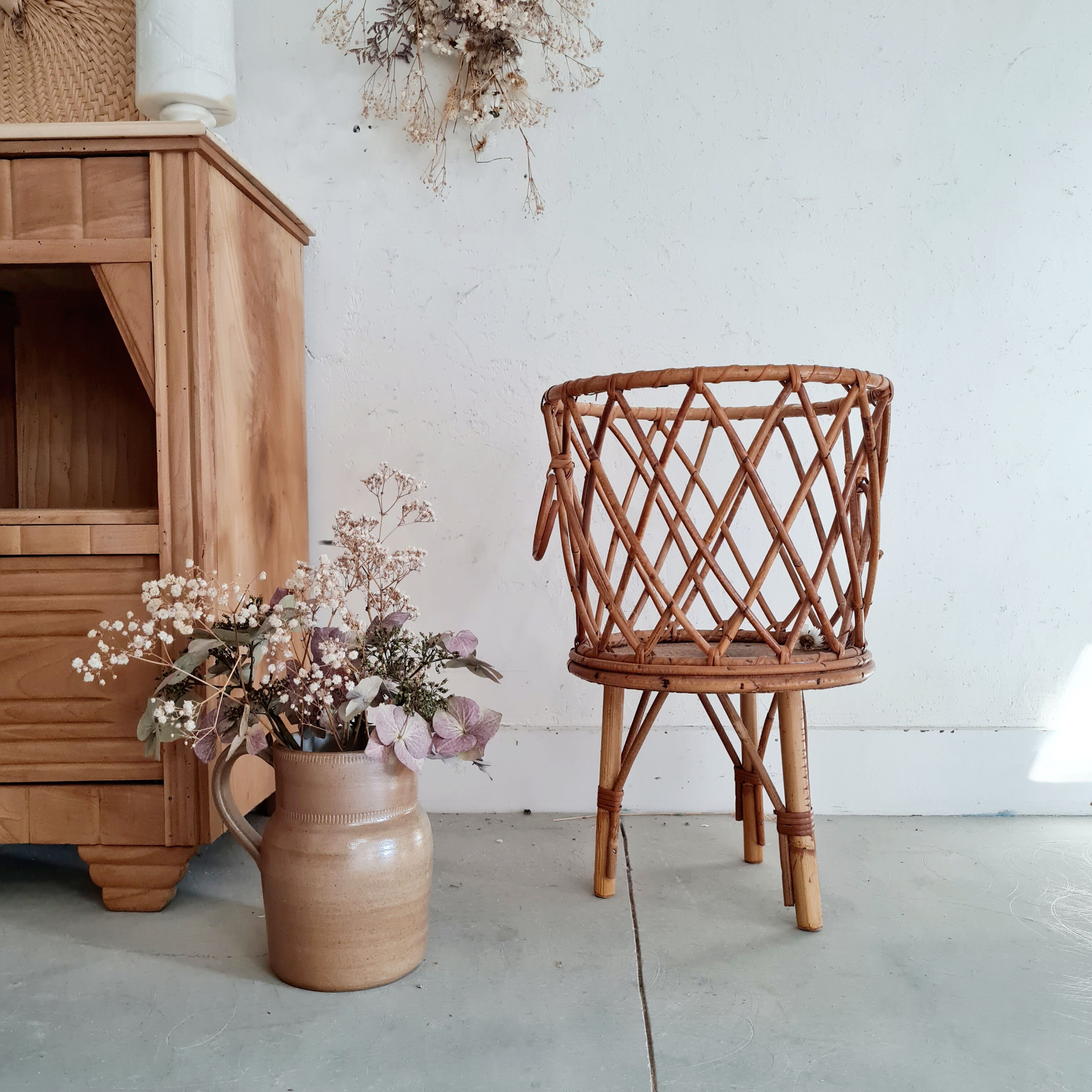 Old tripod rattan plant holder