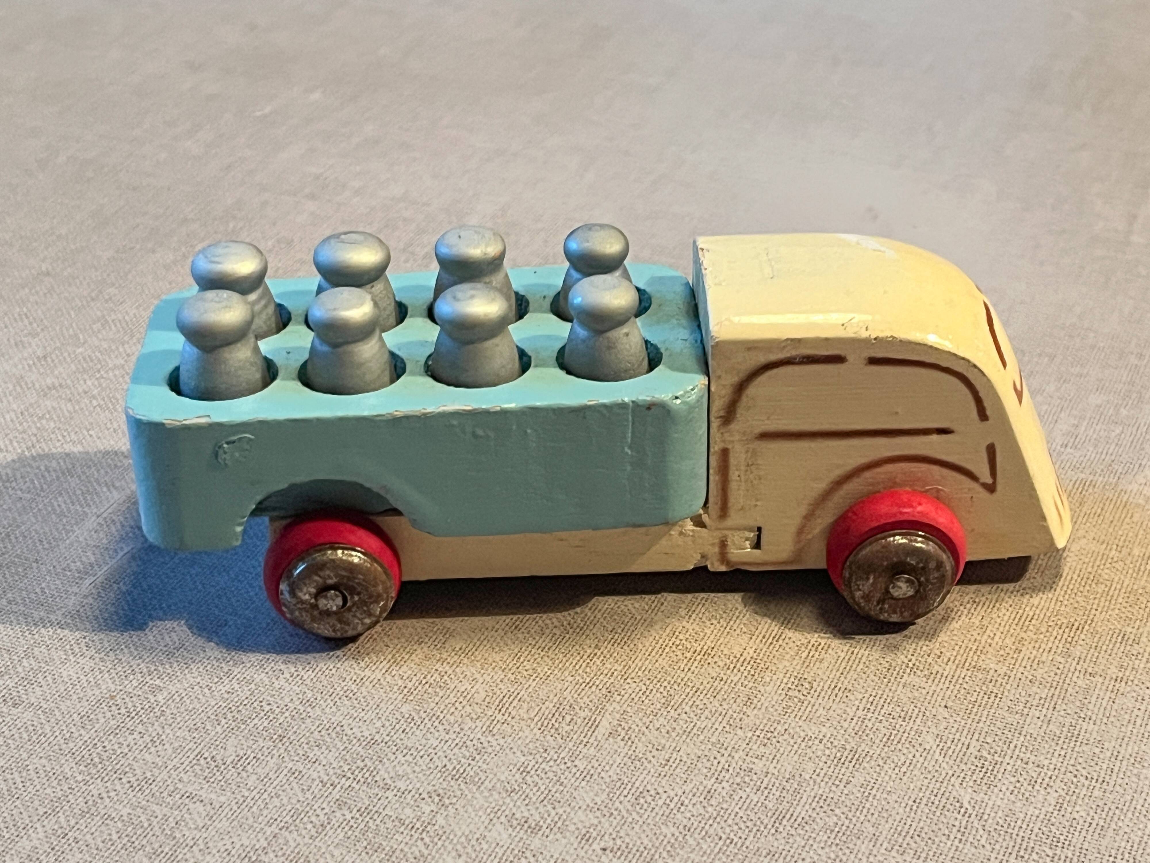 Small wooden milk truck with its cans, antique toy