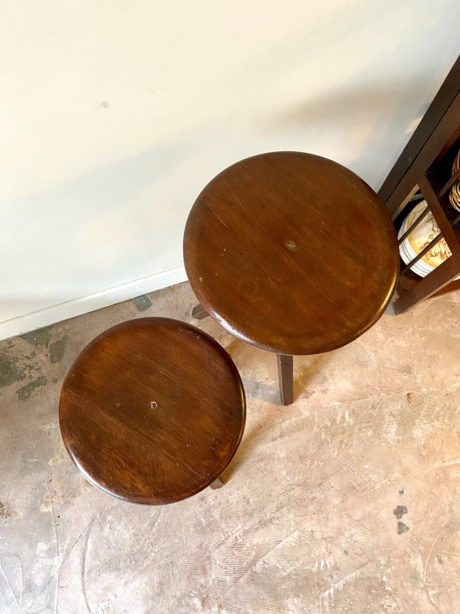 2 tripod stools with dark wood screws