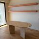 Oblong dining table in beige travertine.