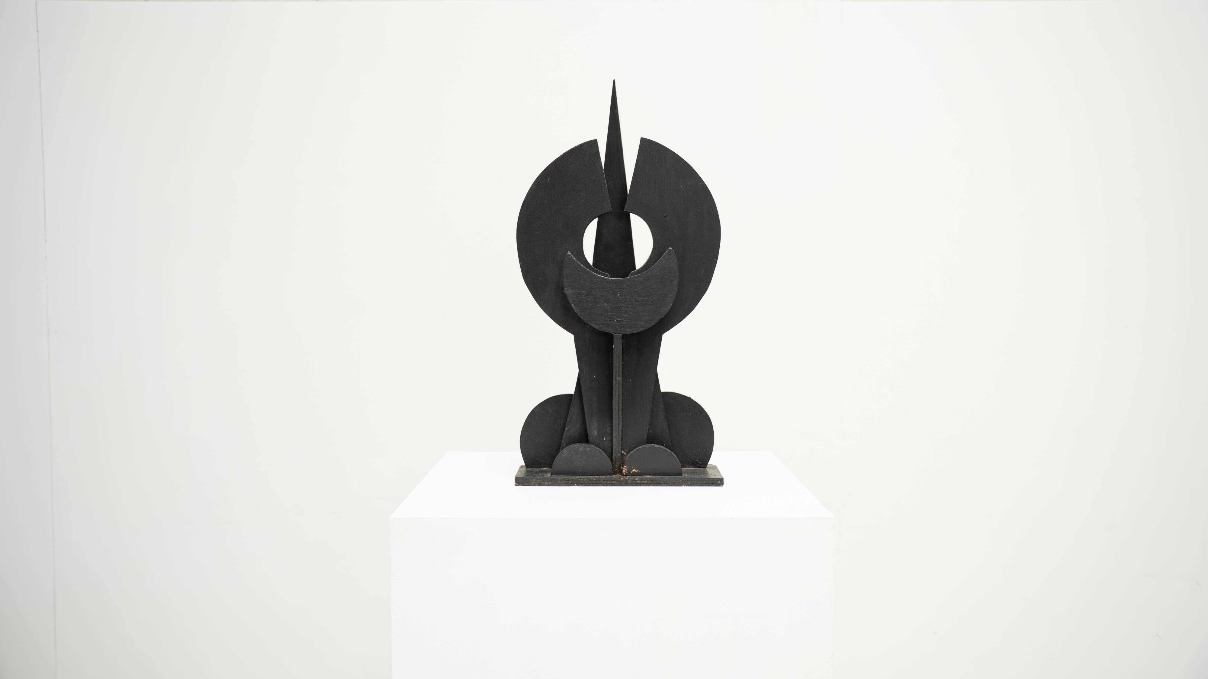 Black brutalist wooden sculpture