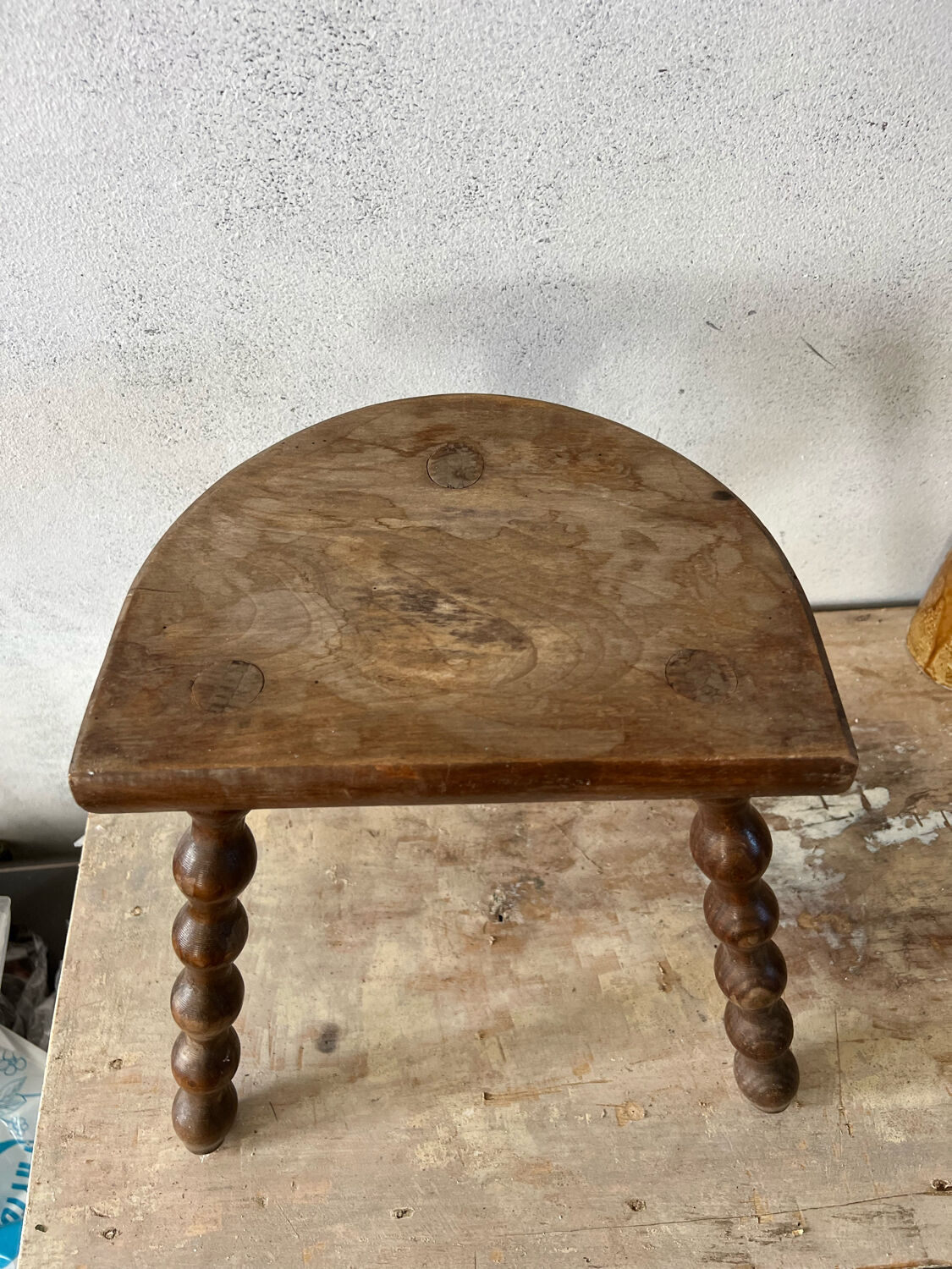 Wooden tripod farm stool