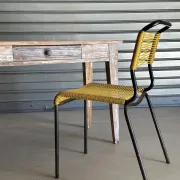 Vintage table made of raw wood with a distressed white base.