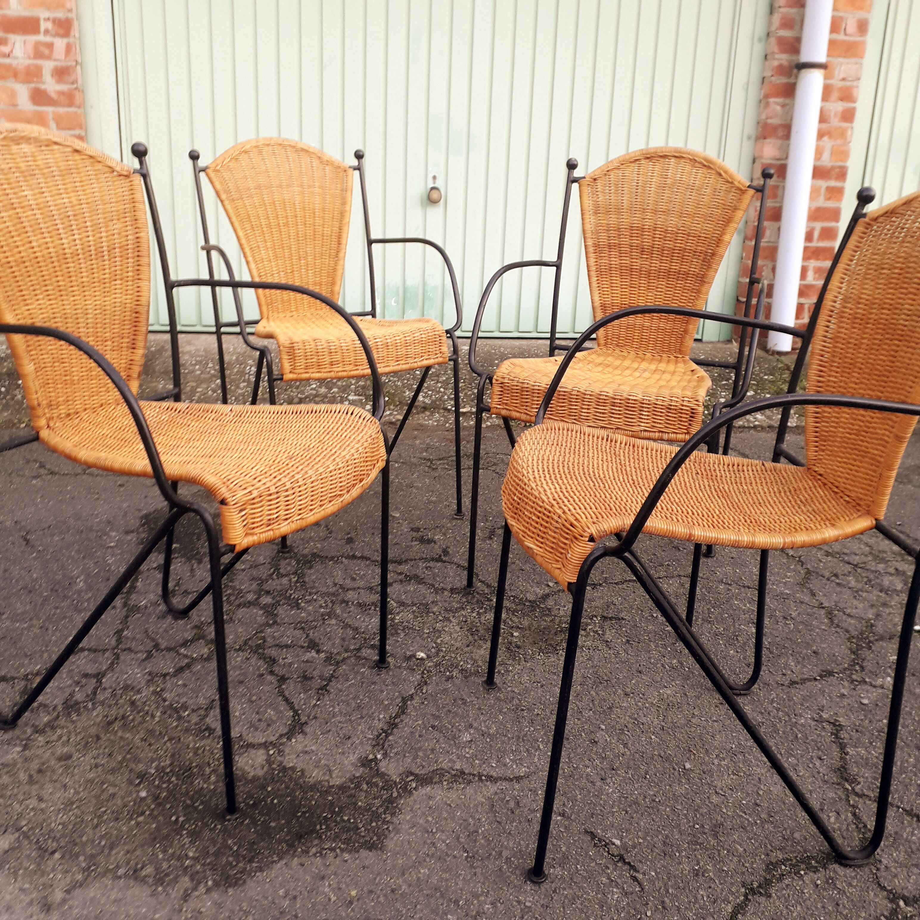 4 vintage wrought iron rattan chairs.