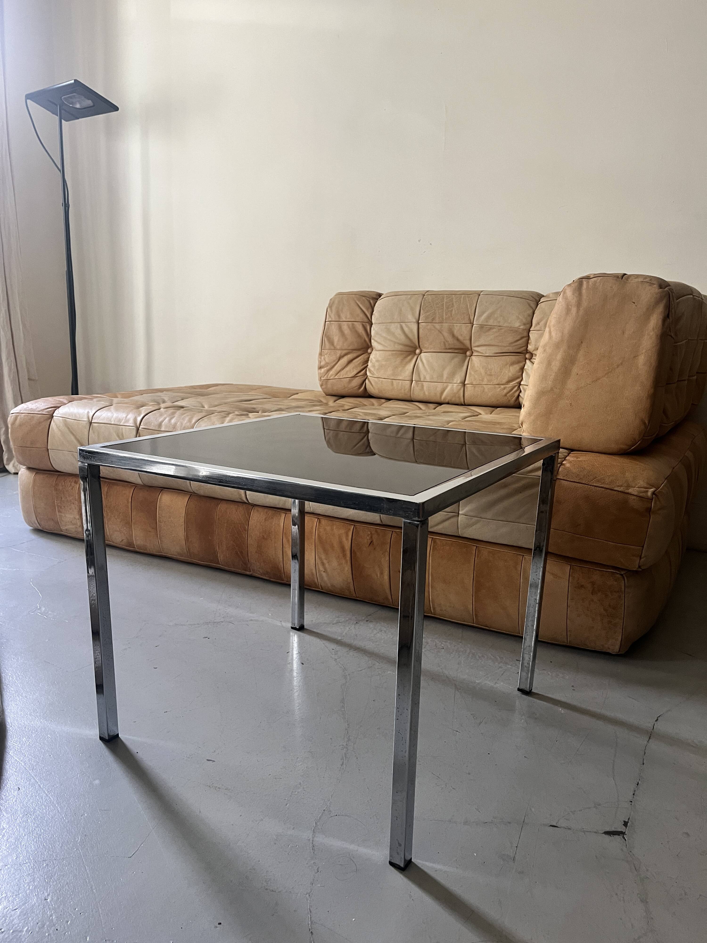 square coffee table in chrome and black glass, design