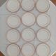 Set of 12 stylised white porcelain dinner plates, signed.