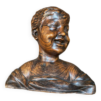 Antique wooden bust of the laughing child by Donatello