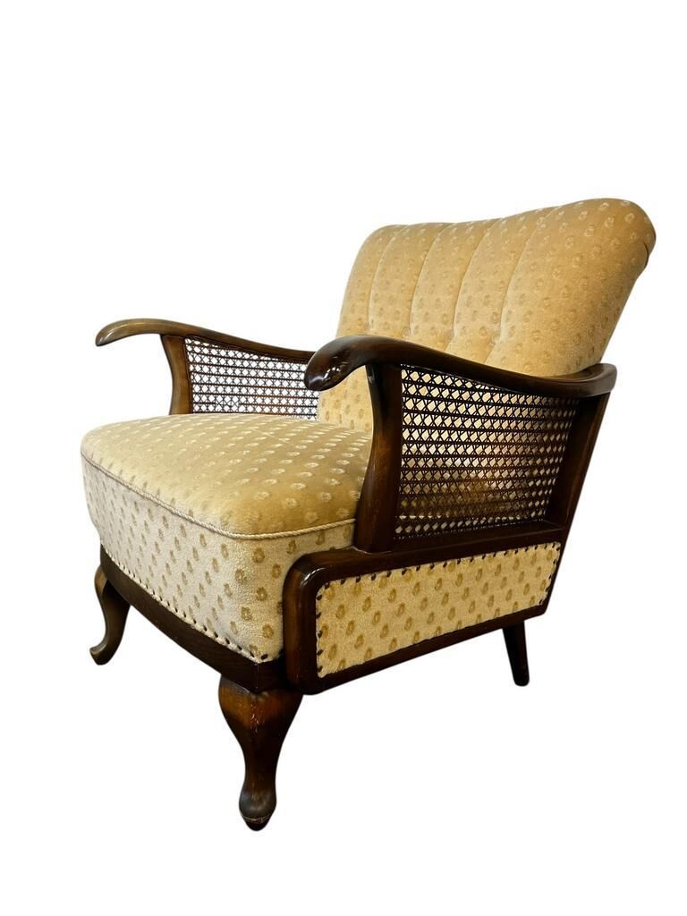 Vintage wooden armchair with rattan weaving.