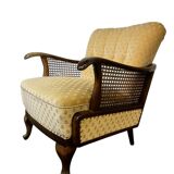 Vintage wooden armchair with rattan weaving.
