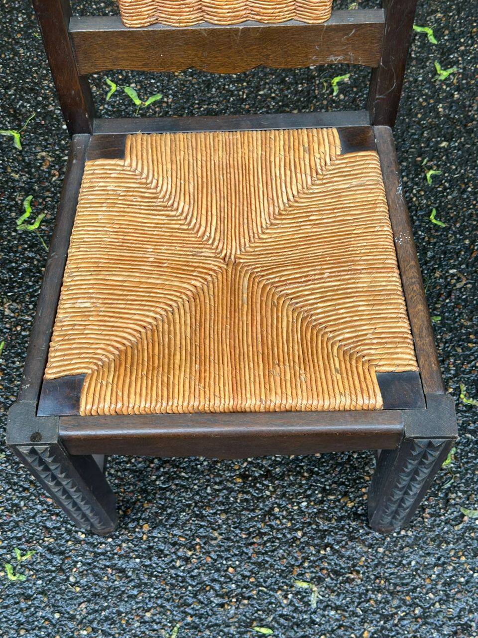 4 Basque solid wood dining chairs with carved straw seats.